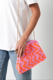 Coole Stoffhandtasche mit Wellenartigem Muster in Pink Orangen Farben und goldener dünner Trage Kette.