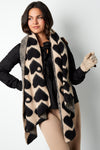 Model trägt weichen Schal mit Herzmuster in Beige und Schwarz
