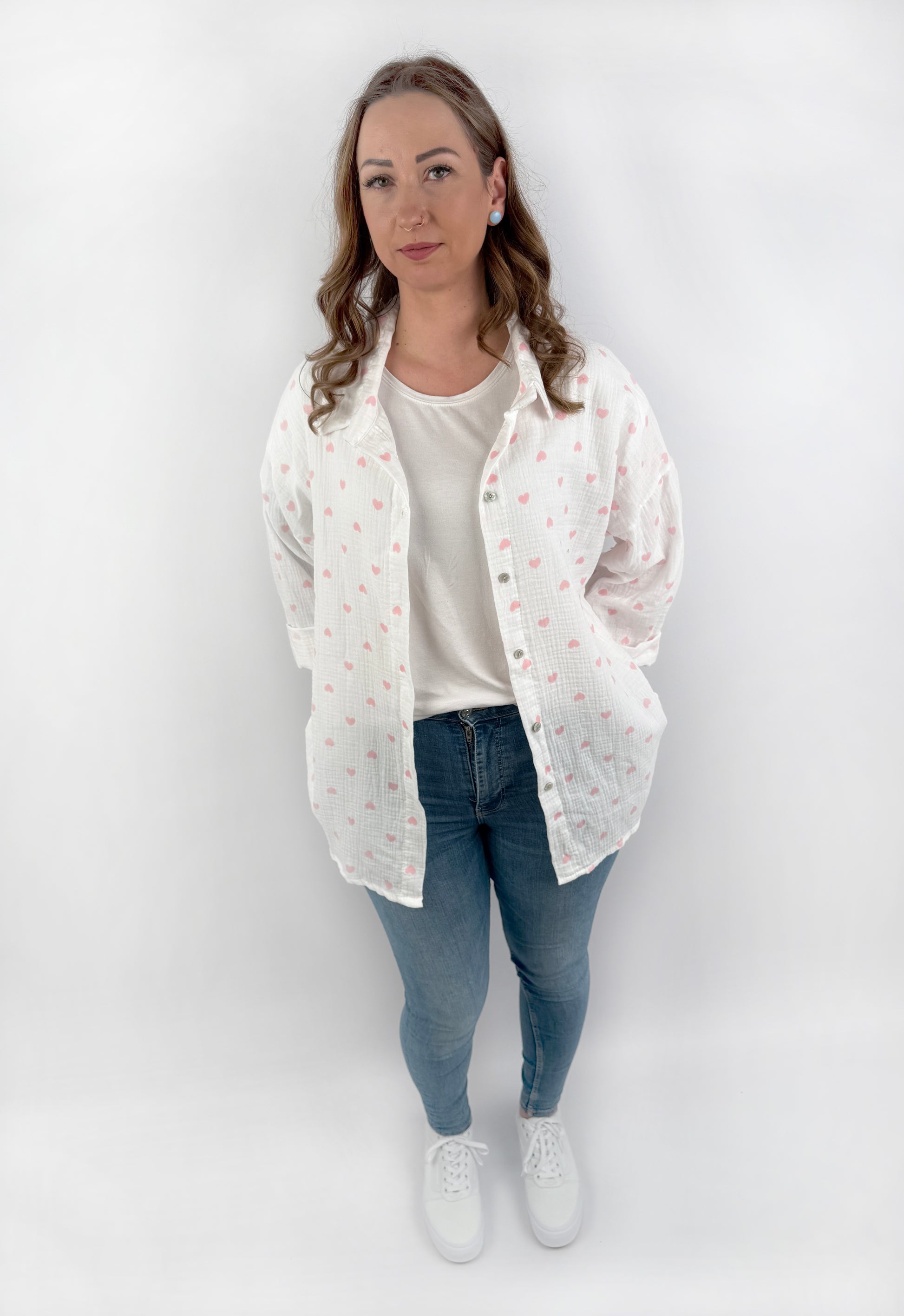 Langärmelige MusselinBluse in weiß mit Pastell farbenen Herzen.