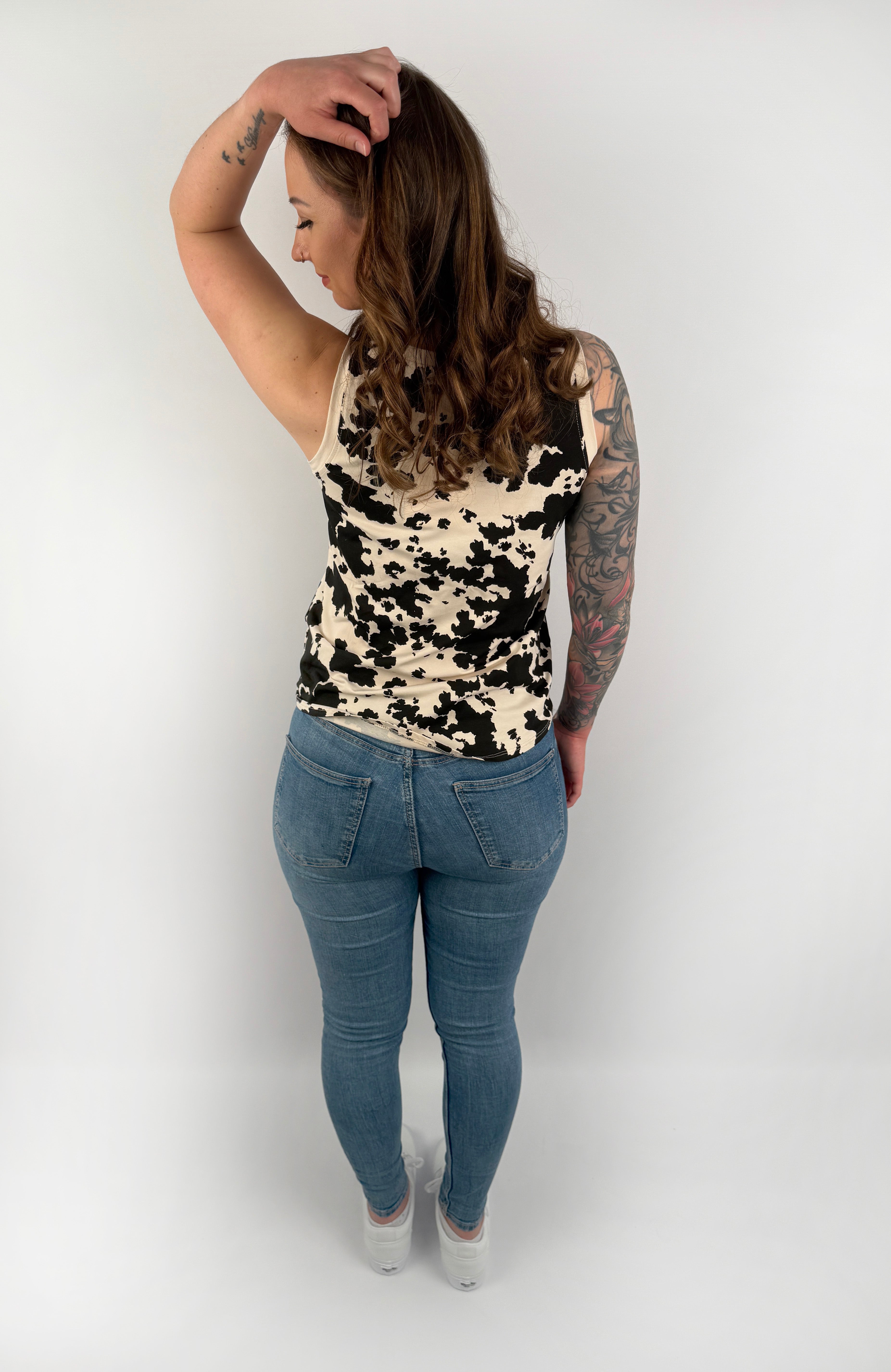 Beiges Tanktop mit schwarzen unregelmäßigen Tupfen.