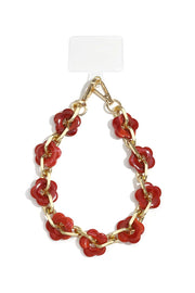 Handykette mit goldener Gliederkette und roten Acryl-Blumen auf weißem Hintergrund