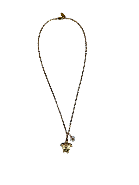 Goldene Edelstahl Halskette mit goldenem Schildkrötenanhängerund weißem Blumen Anhänger.
